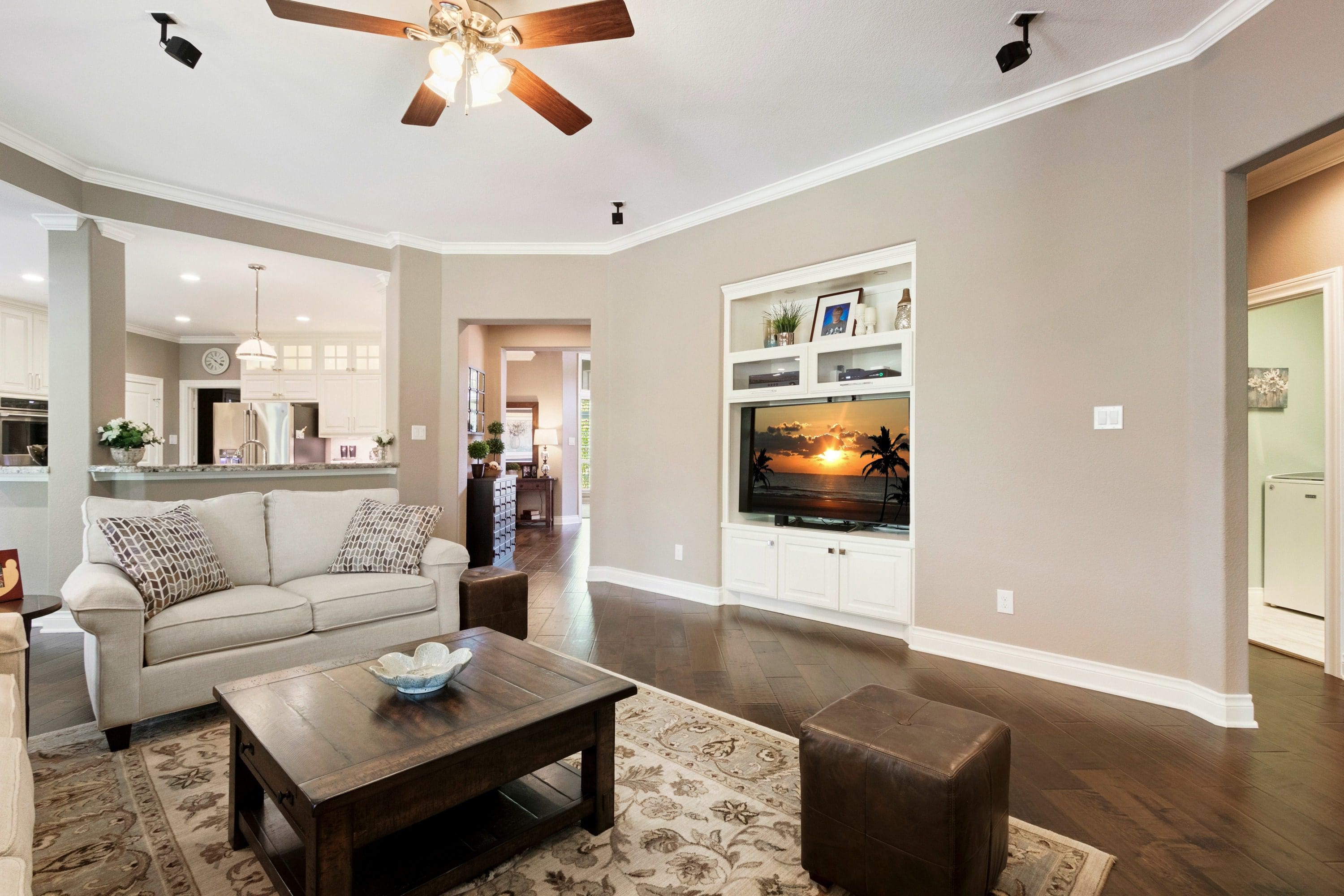 A living room with a couch, coffee table and television.
