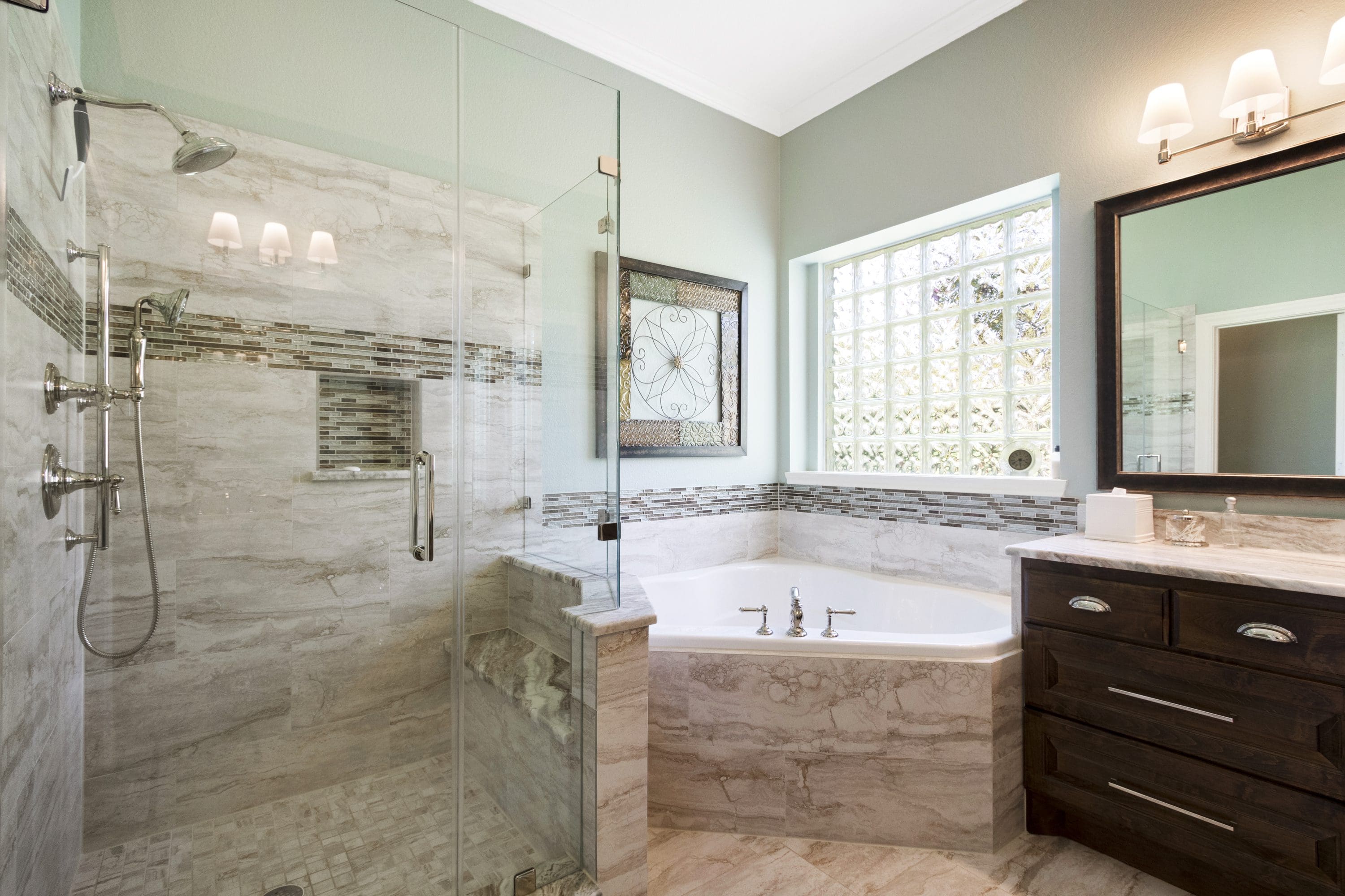 A bathroom with a large tub and walk in shower.