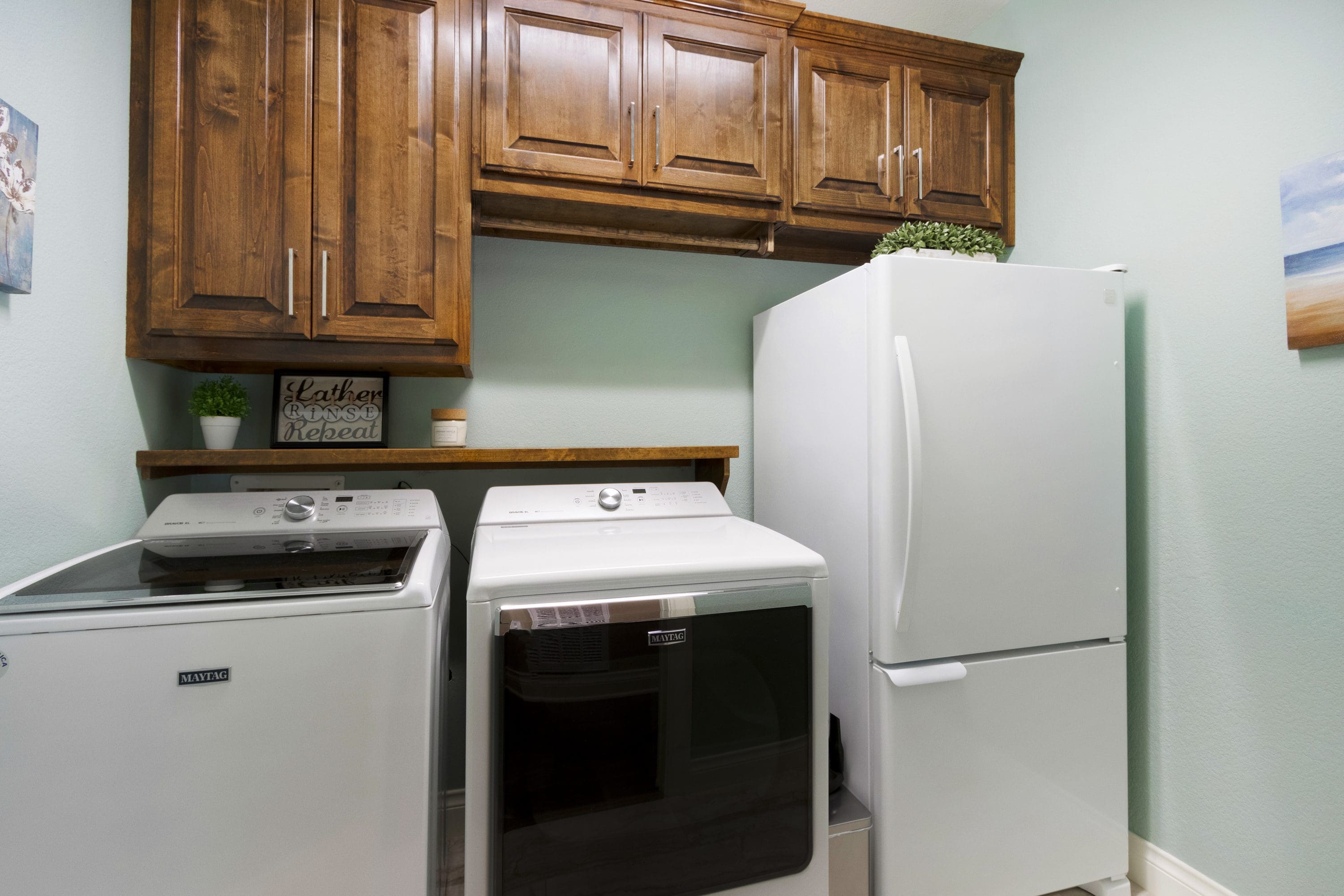 A kitchen with brown cabinets and white appliances.