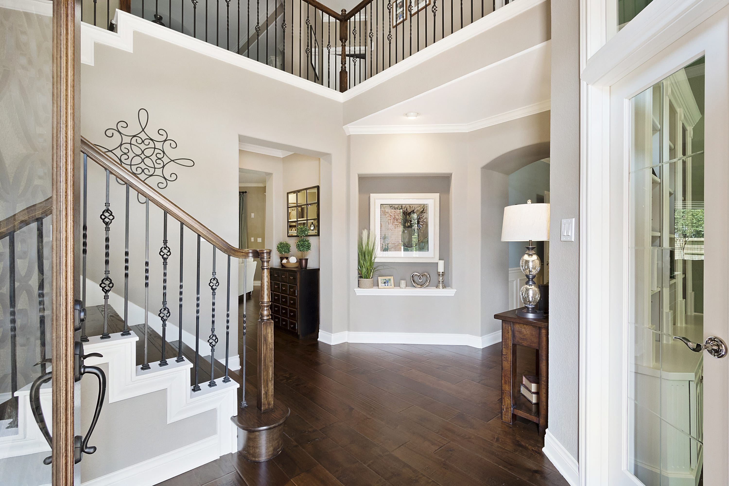 A large open foyer with a staircase and an entryway.