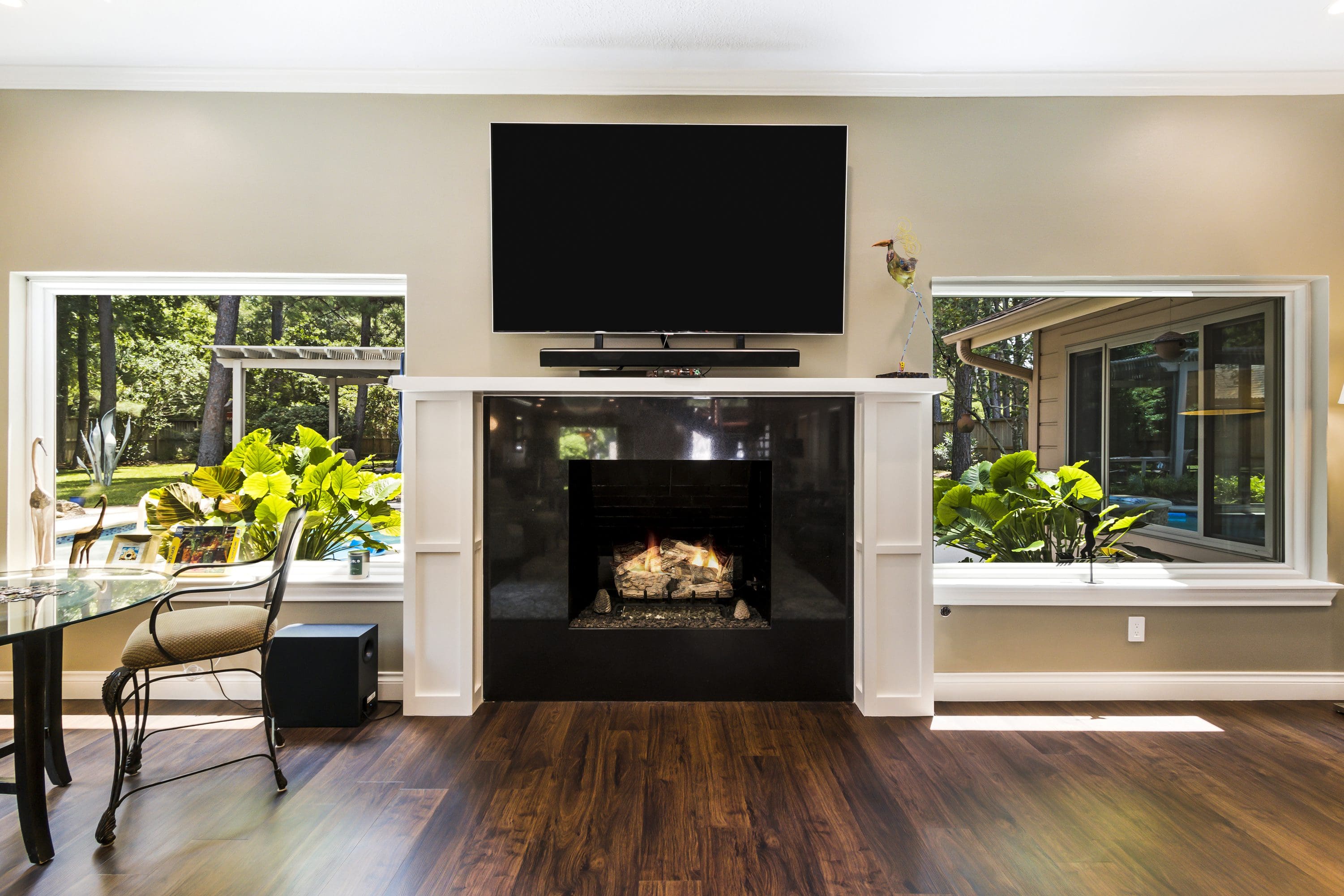 A living room with a fireplace and television.