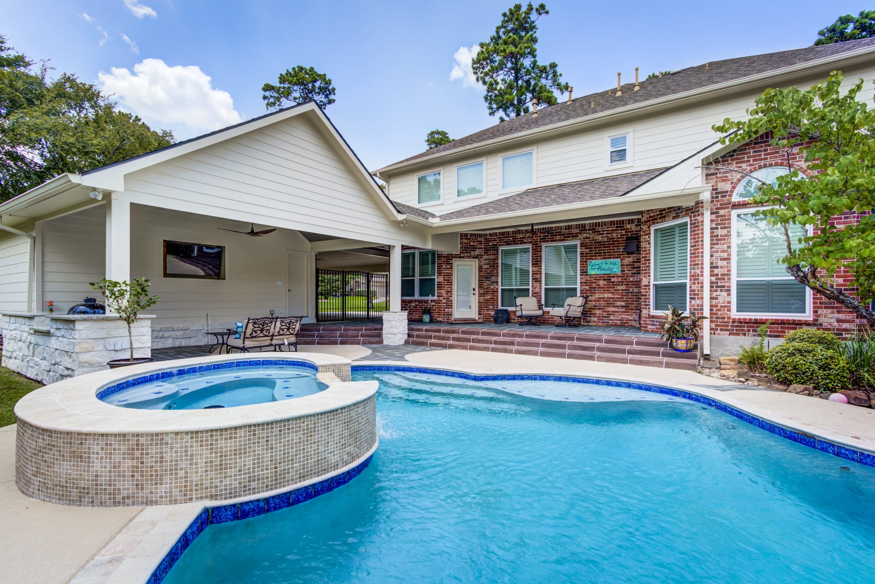 A large pool with a hot tub in the middle of it.