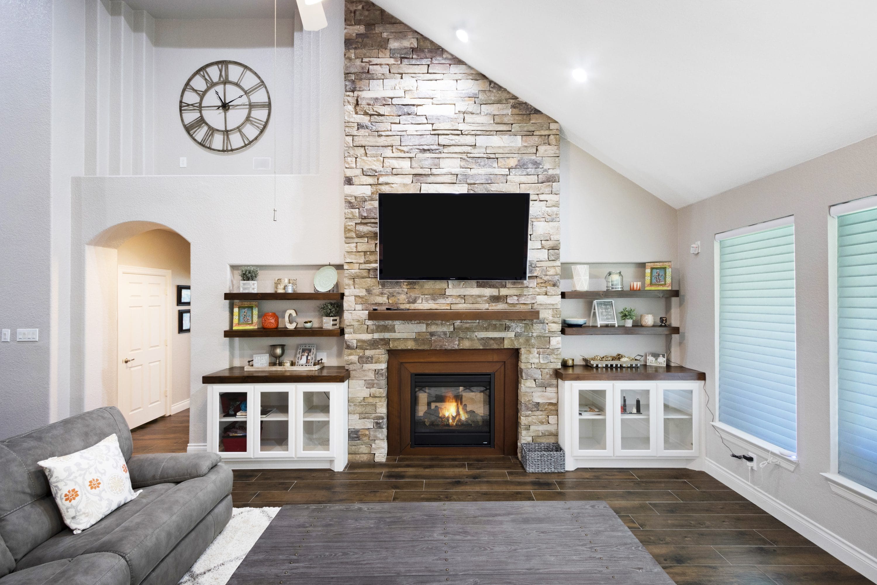 A living room with a fireplace and tv