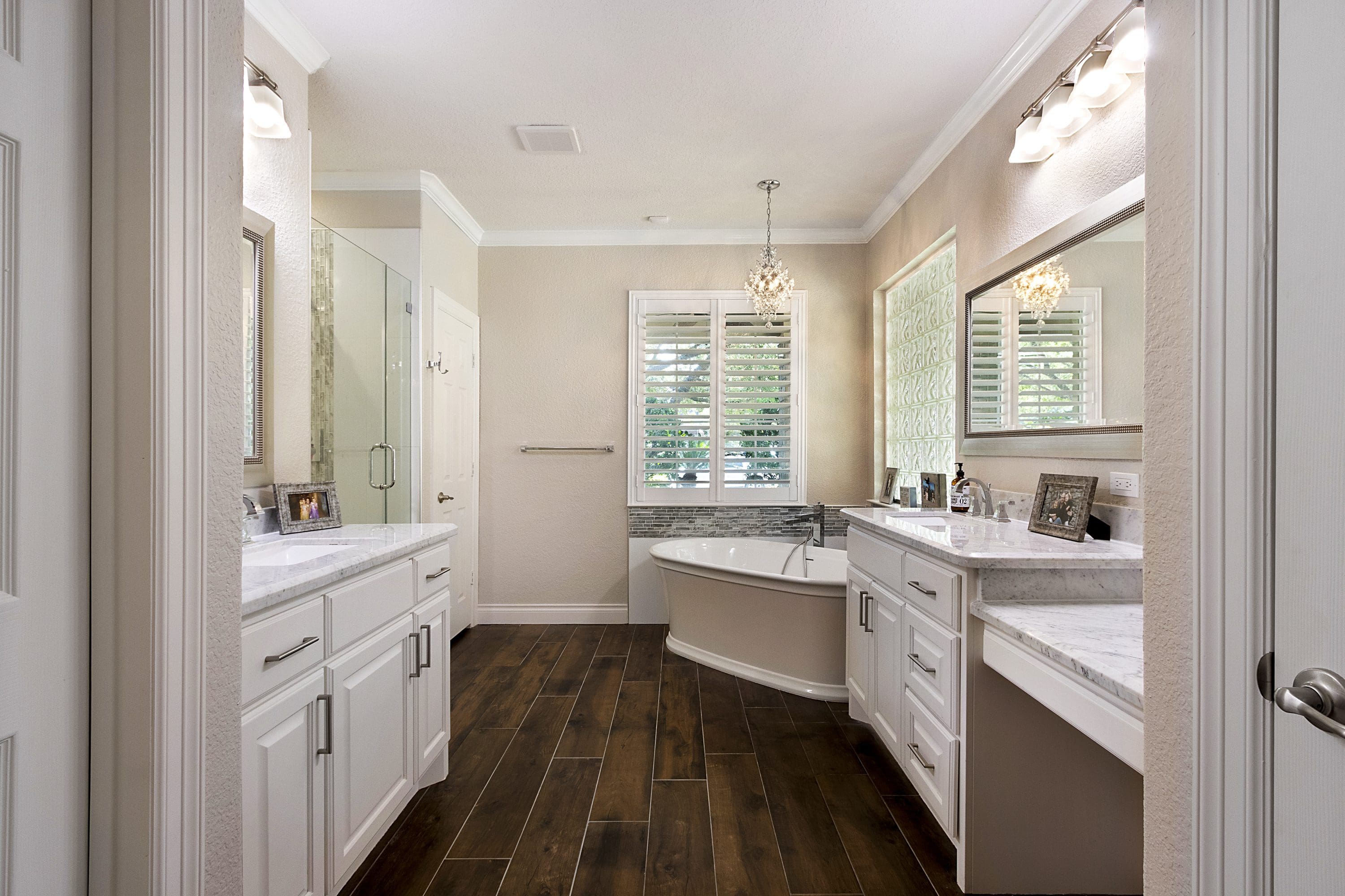A bathroom with two sinks and a large mirror.