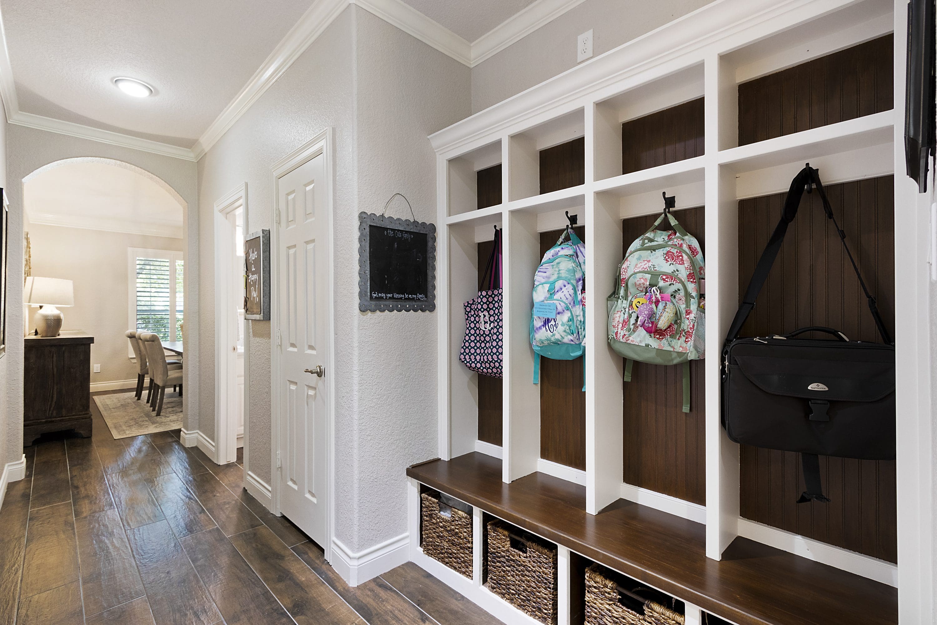 A hallway with cubbies and baskets for storage.