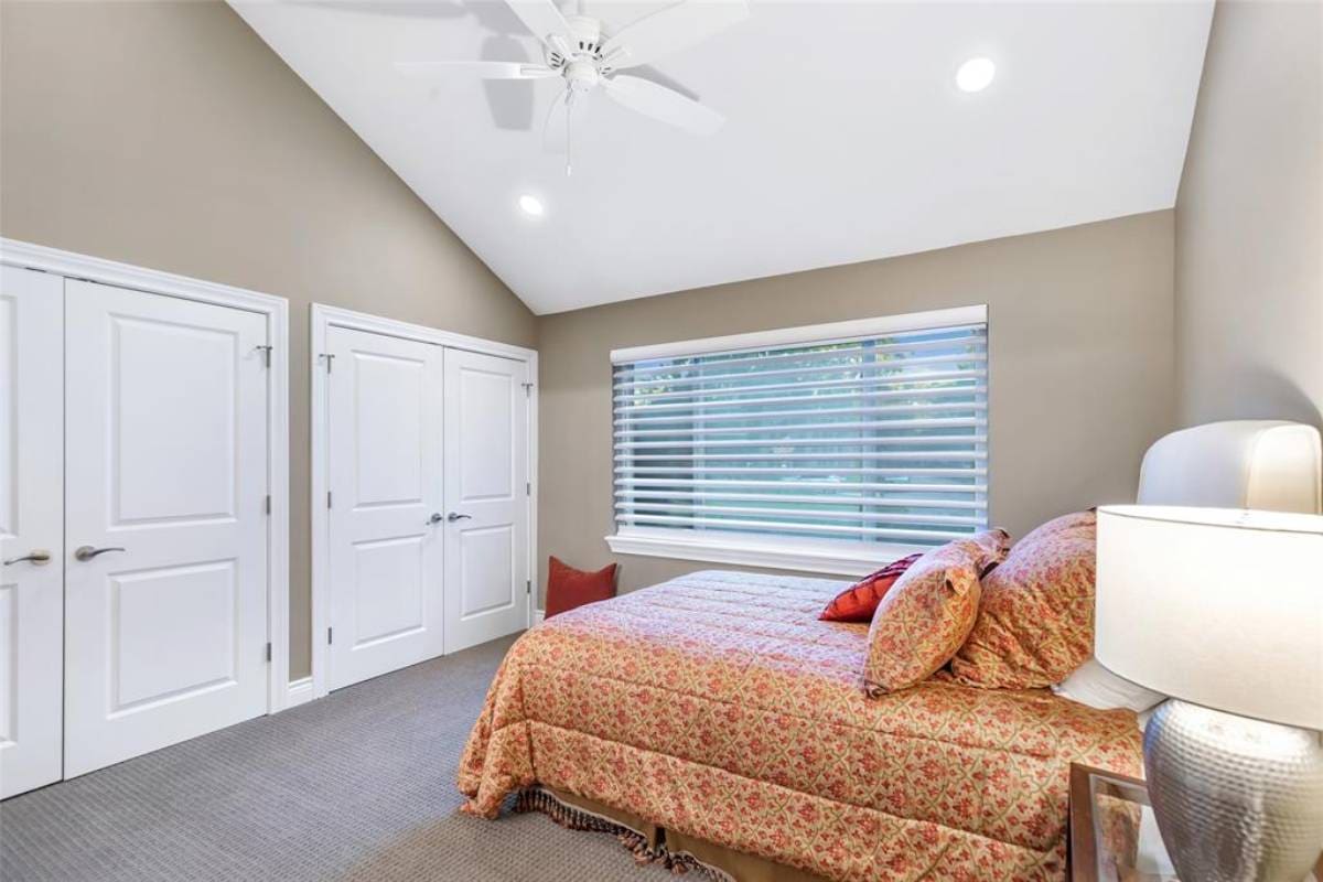 GettyImages-901157728-3 (1) A bedroom with a bed, dresser and window.