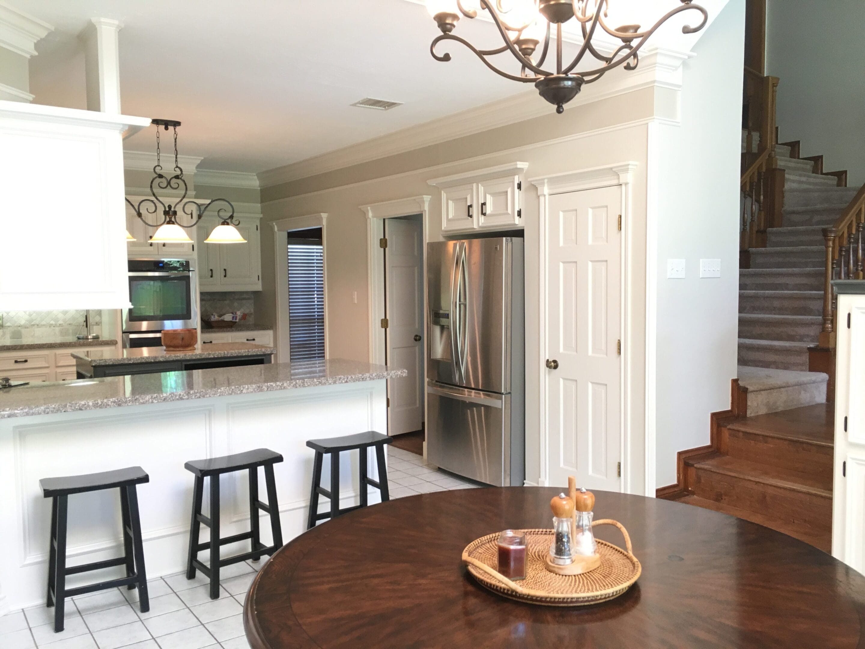 A kitchen with a table and chairs in it