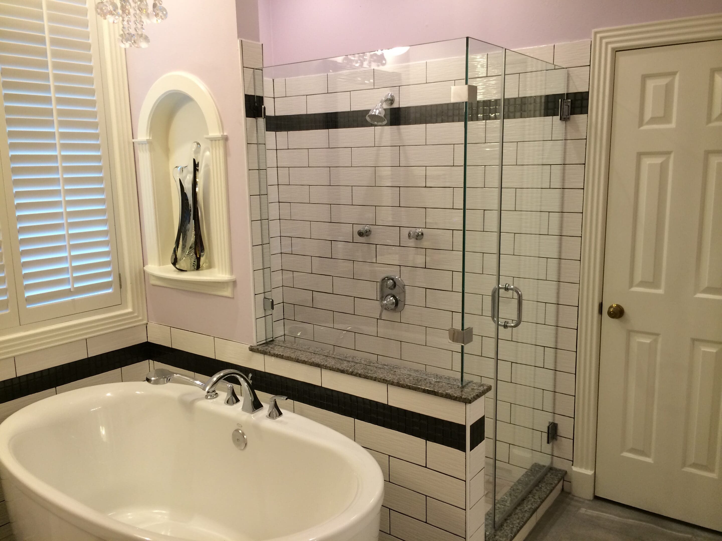 A bathroom with a tub and shower in it