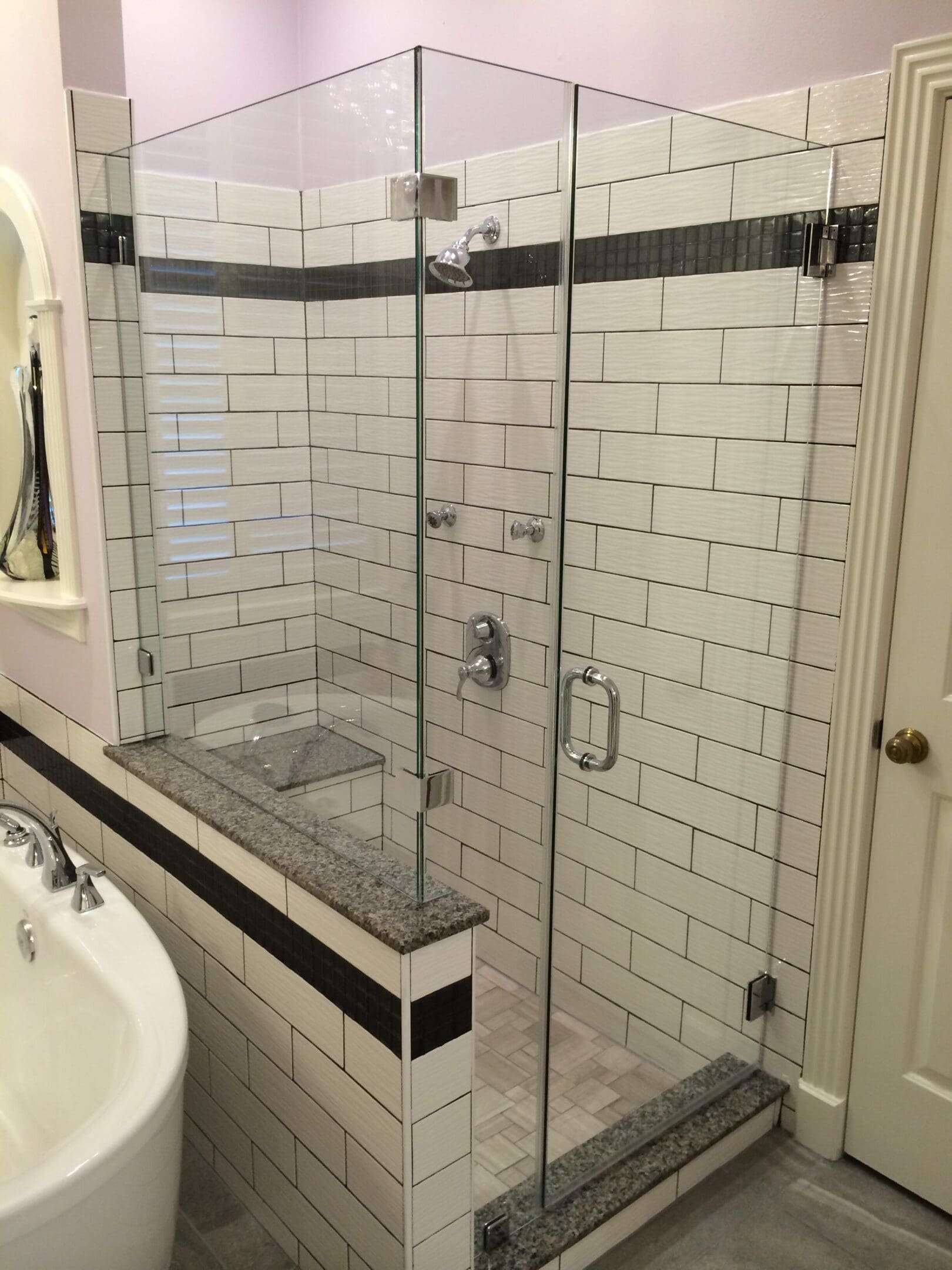 A bathroom with a shower and tub in it