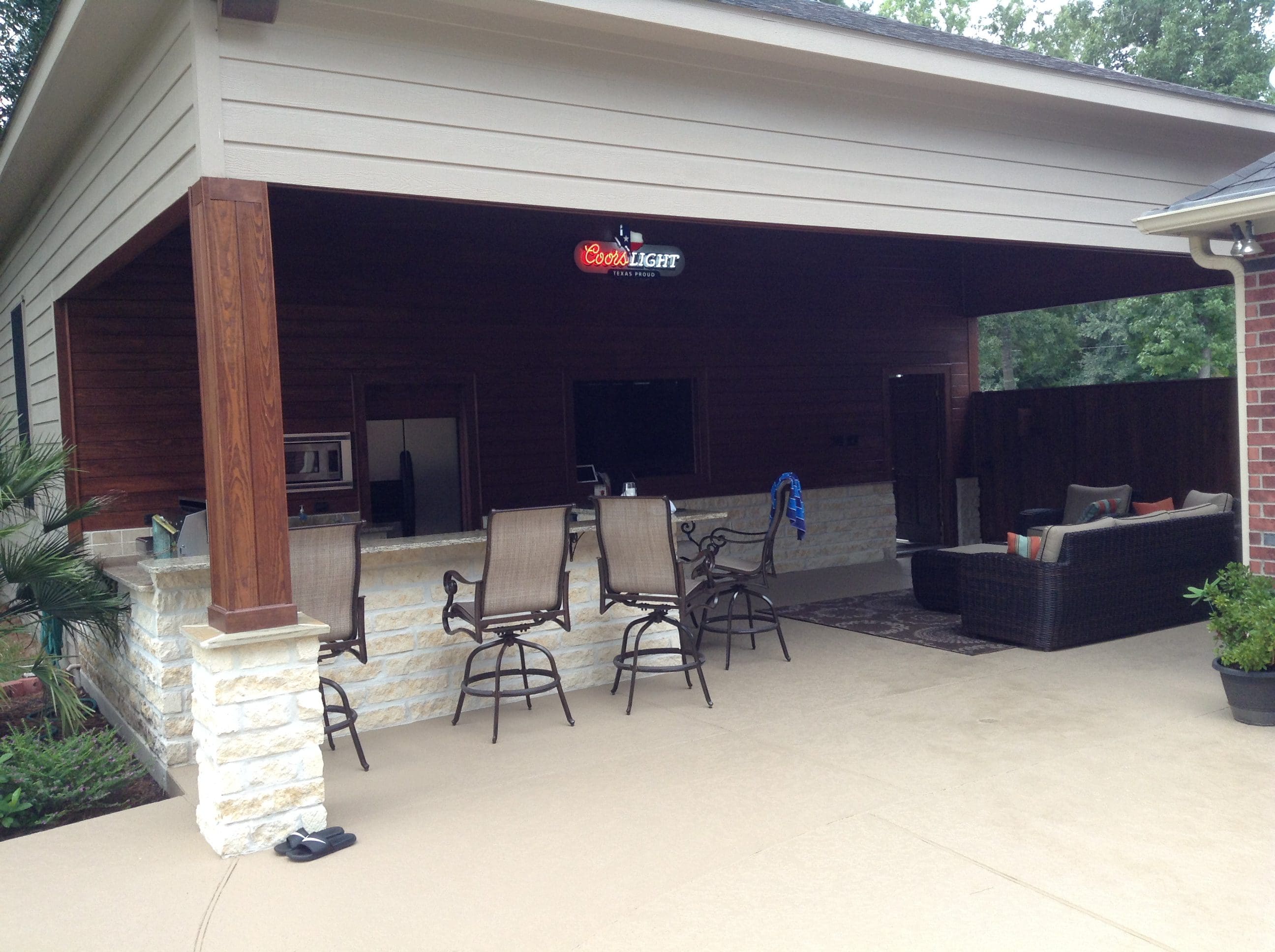 A patio with chairs and an open air pavilion.