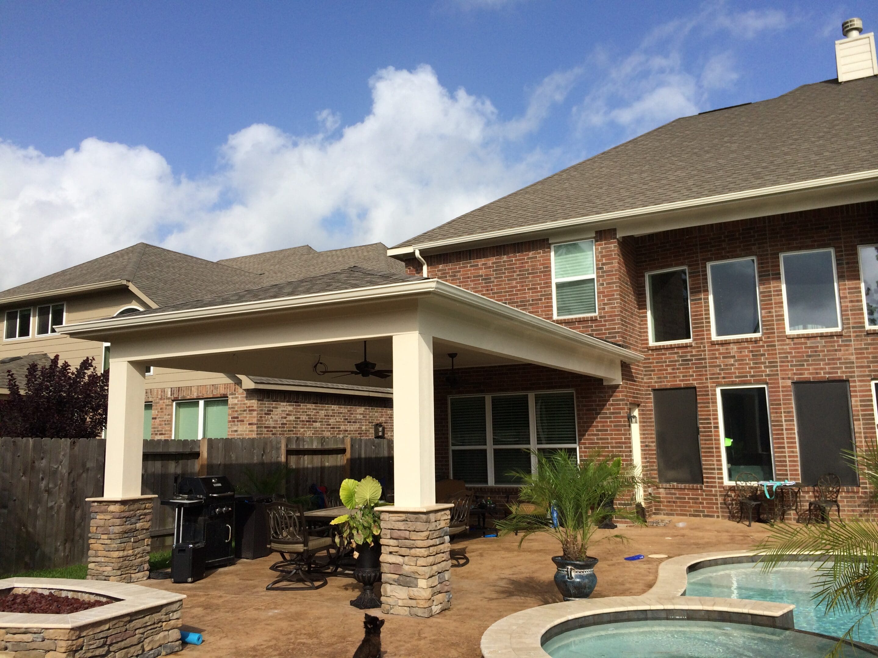 A large brick house with a pool and patio.