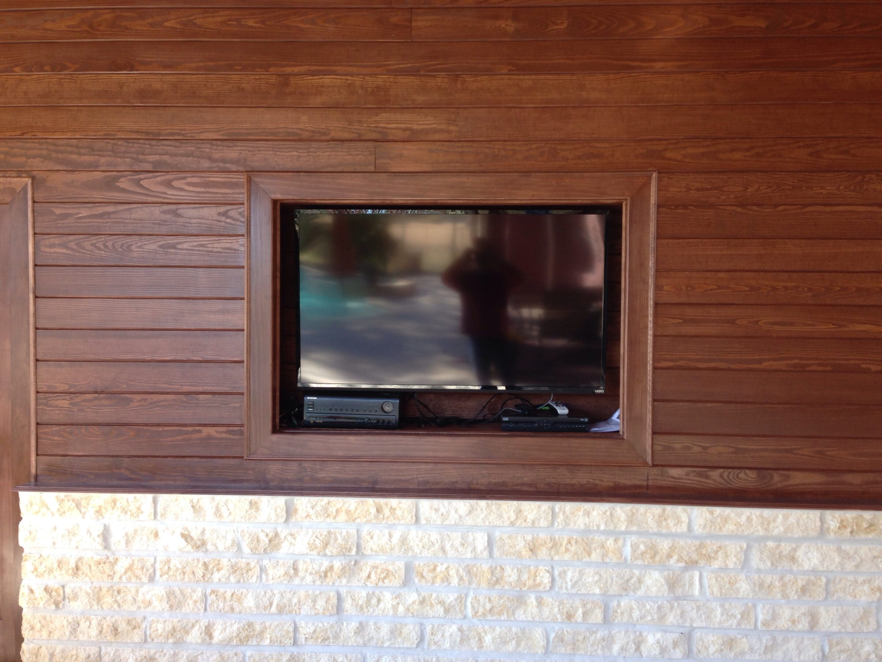 A television is shown in the middle of a wall.