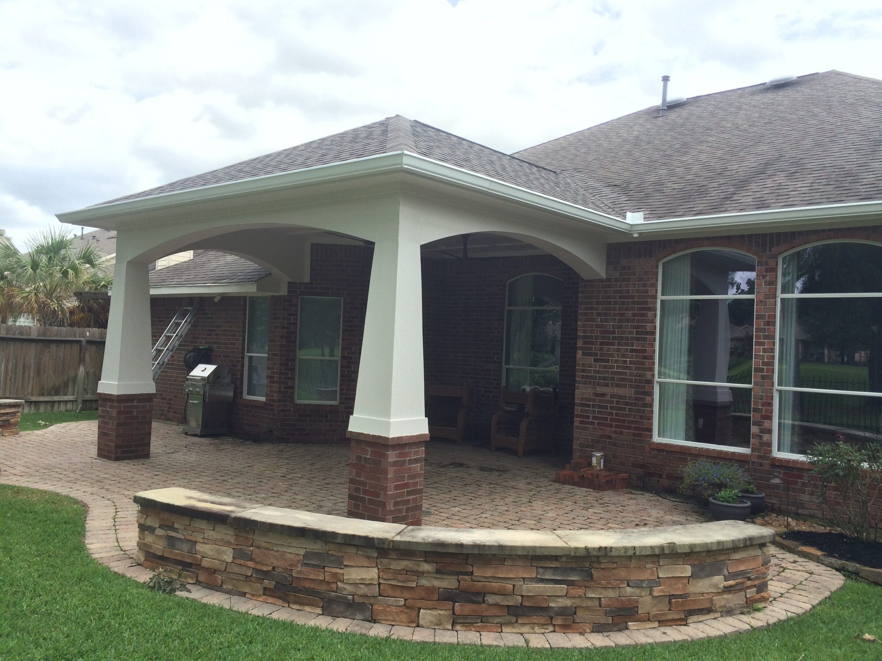 A patio with stone walls and a brick wall.