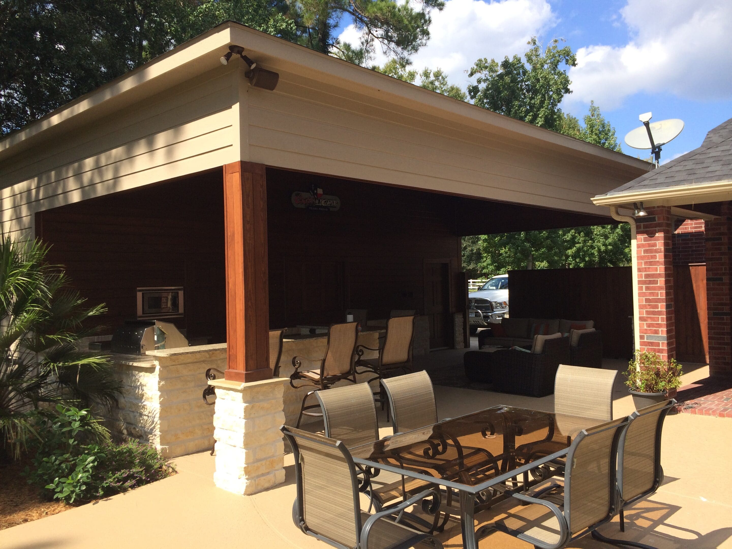 A patio with tables and chairs under an awning.