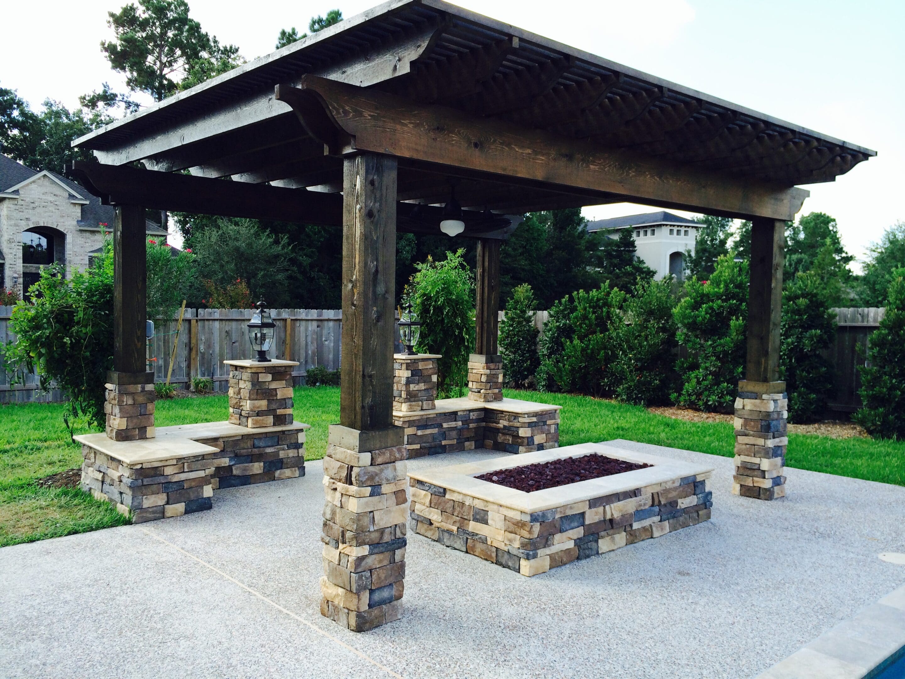 A large outdoor fire pit under an open pavilion.
